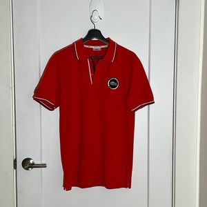 Lacoste polo shirt w/embroidered Lacoste accents.